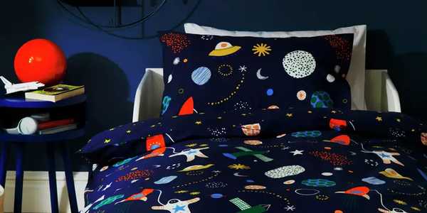A universe-themed single bed duvet set in a kids room.
